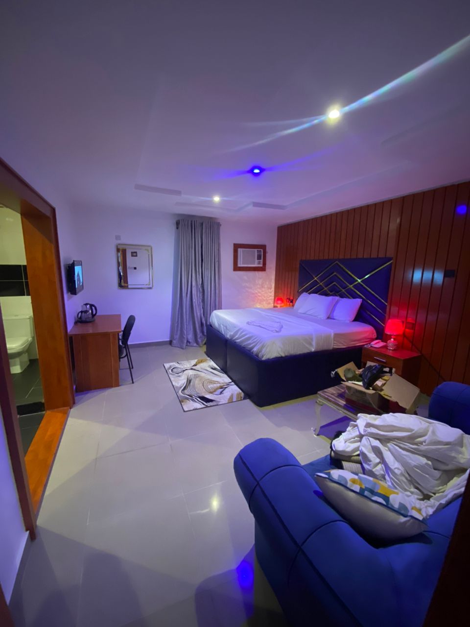 Premium suite with blue geometric headboard and LED lighting