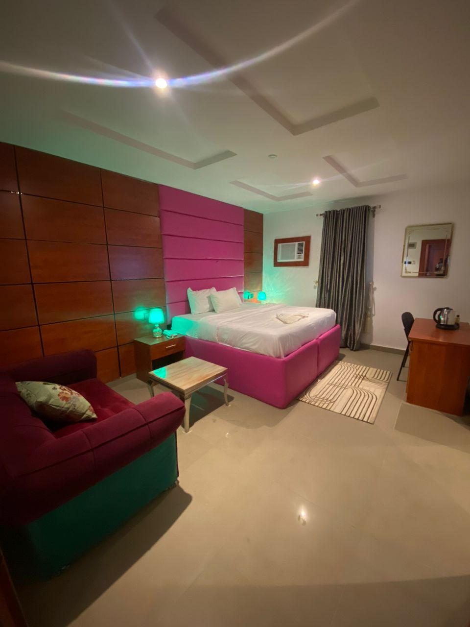 Deluxe room with pink accents and green LED lighting